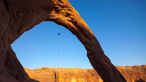 A man rappels off Corona Arch near Moab, Utah, United States (© Grant Ordelheide/TANDEM Stills + Motion)