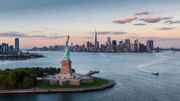 Statue of Liberty and Lower Manhattan, New York City (© Tetra Images/Getty Images)