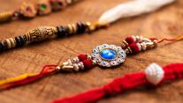 Handmade threads rakhis kept on a wooden surface 