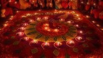 Oil lamps arranged on a rangoli to celebrate Diwali in Guwahati, India 