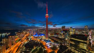 CN Tower illuminated at night in Toronto, Ontario (© R.M. Nunes/Shutterstock)